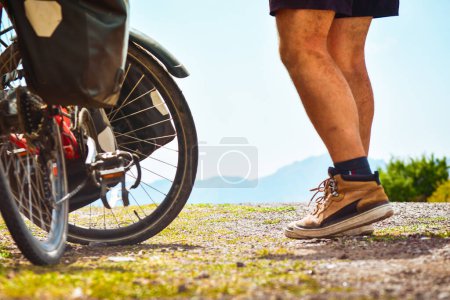 Photo for Isolated fit young caucasian male person stand by bicycle with mountains background outdoors in caucasus mountains. Achievement , inspiration, challenge and determination concept - Royalty Free Image