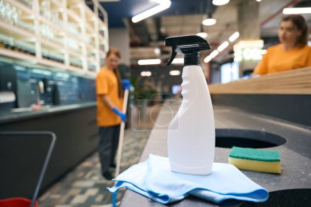 Photo for Teamwork of young, pretty cleaners in a coworking space, professional devices in the foreground - Royalty Free Image