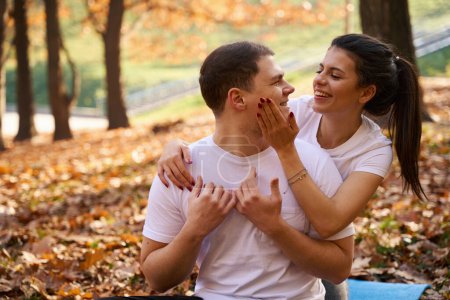 Photo for Charming young woman hugging her boyfriend, they are relaxing in nature - Royalty Free Image