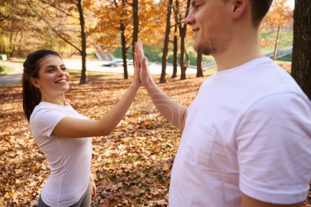 Photo for Smiling young man and his girlfriend greet each other, they met in the city park - Royalty Free Image