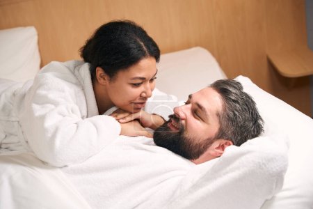 Photo for Woman in love lying on chest of her smiling happy young man - Royalty Free Image