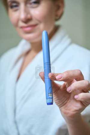 Photo for Female holds an injection syringe in her hands, a woman has a neat manicure - Royalty Free Image