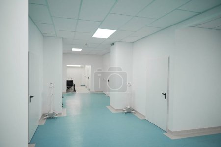 Photo for There is a wheelchair and special tripods in a bright hospital corridor - Royalty Free Image