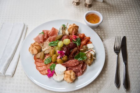 Photo for Close-up plate with different sausages, meat and cheese, antipasto, gastronomy delicious - Royalty Free Image