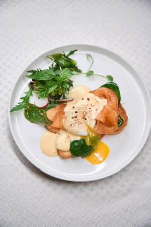Photo for Tasty delicious brunch with salmon and poached egg on toast, top-view, gluten-gree cuisine - Royalty Free Image