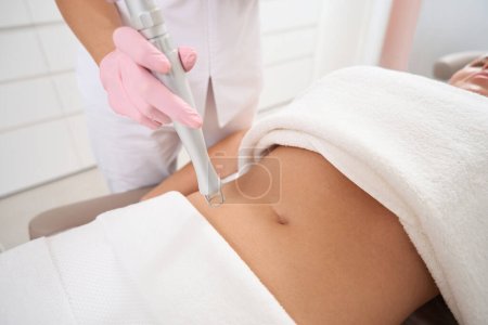 Photo for Patient on a cosmetic procedure at an esthetician, in clinic of aesthetic medicine, laser peeling and CO2 resurfacing are used - Royalty Free Image