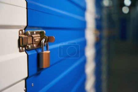 Photo for Close lock is hanging on the deadbolt of doors from a storage box in a warehouse - Royalty Free Image