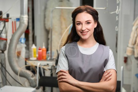Photo for Professional dry cleaning service operator smiling, looking at camera standing at workplace, high-quality laundry - Royalty Free Image