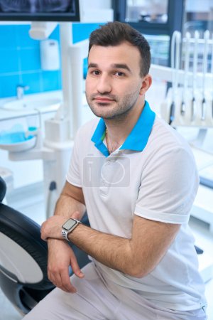 Téléchargez les photos : Dentiste au travail à la chaise dentaire, équipement moderne autour - en image libre de droit