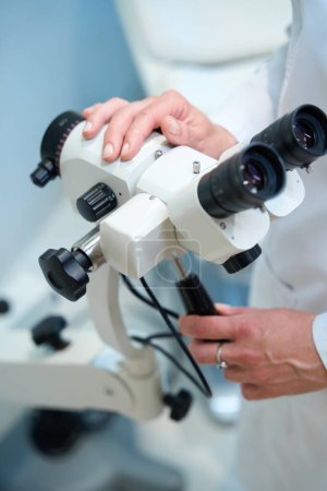 Téléchargez les photos : Gynécologue sur le lieu de travail dans un cabinet gynécologique, le médecin utilise un microscope gynécologique dans son travail - en image libre de droit