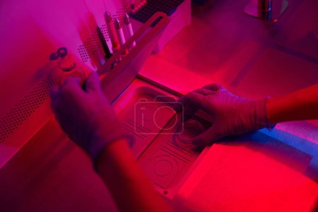 Photo for Cropped photo of laboratory assistant hands opens the lid into a special apparatus, sterile conditions in the laboratory - Royalty Free Image