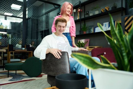 Téléchargez les photos : Guy et sa copine choisissent des meubles pour leur maison dans un salon de design - en image libre de droit