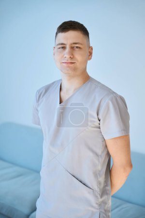 Photo for Cute physiotherapist at workplace in wellness center, comfortable sofa in interior - Royalty Free Image