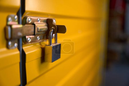 Photo for Yellow metal door is locked, this is a modern storage room - Royalty Free Image
