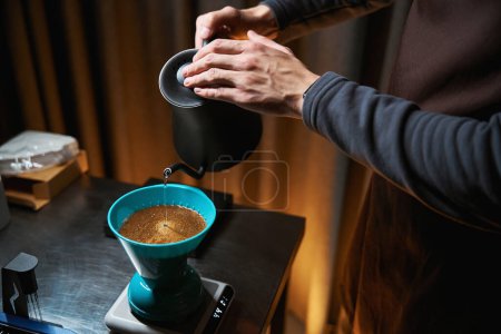 Photo for Barista using pour over dripper and filter alternative coffee brewing method in coffee house - Royalty Free Image
