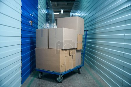 Photo for Boxes with things on a cart in the hallway of a storage hangar - Royalty Free Image