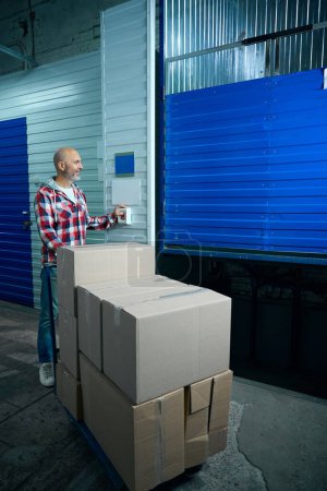 Photo for Man opens a storage room for things. High quality photo - Royalty Free Image