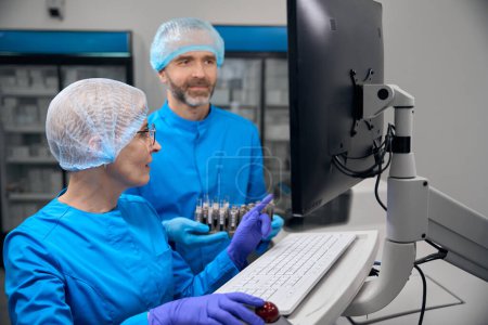 Foto de Asistentes de laboratorio utilizan equipos de alta tecnología en su trabajo, las personas en un laboratorio moderno - Imagen libre de derechos
