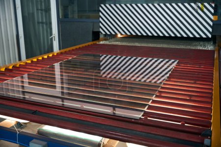 Photo for Technological process of glass tempering using thermal equipment, high-tech devices are used in production - Royalty Free Image