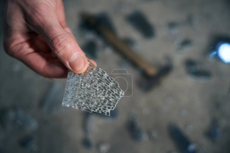 Photo for Worker holds a piece of triplex glass in his hands, the features of triplex technology are visible - Royalty Free Image