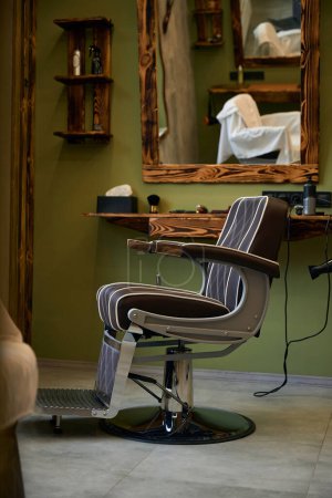 Photo for Empty barbershop chair in stylish hairdressing salon interior - Royalty Free Image