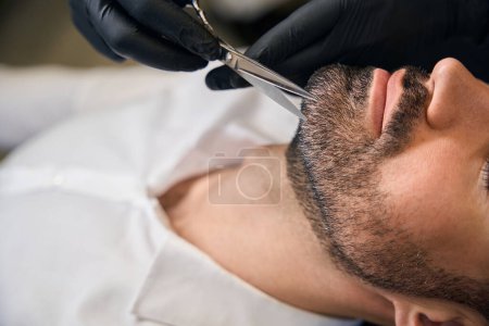 Photo for Styling of man customer beard in professional barbershop - Royalty Free Image