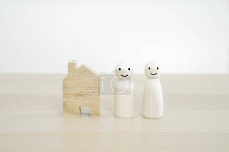 Photo for Happy family and New home concept. Family wooden peg doll on wood table. - Royalty Free Image