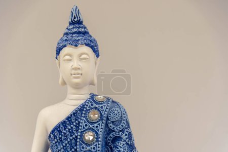 Photo for Blue buddha image on white background. Buddhism. Spirituality and religion. Meditation image. Buddha meditating. - Royalty Free Image