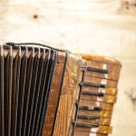 Old accordion piano. Wind musical instrument. Safona for students. Wind instrument and bellows.