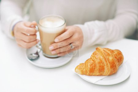 Photo for Close up image of freshly baked croissant and cafe latte - Royalty Free Image