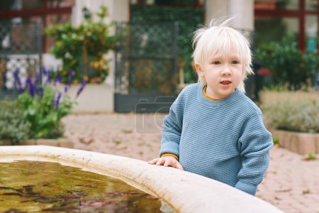 Outdoor portrait of adorable little boy playing outside