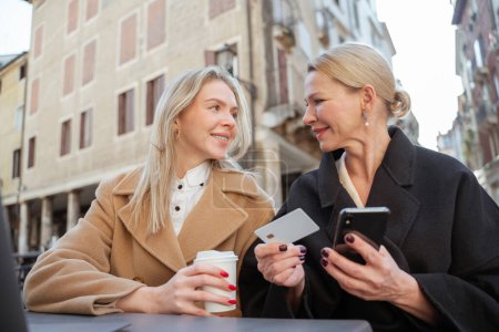 Photo for Mobile network. Two woman discussing how to connect to internet through mobile network - Royalty Free Image