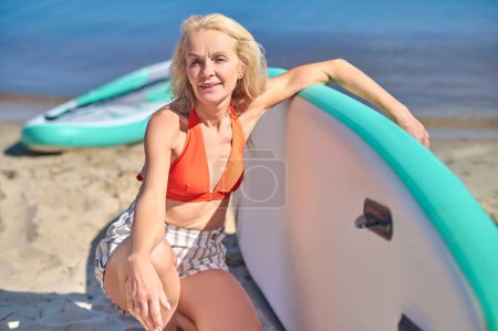 Photo for With a kayak. Beautiful mature woman with a kayak on the beach - Royalty Free Image