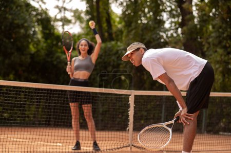 Photo for Winner. Young girl won a game in tennis and looking happy - Royalty Free Image