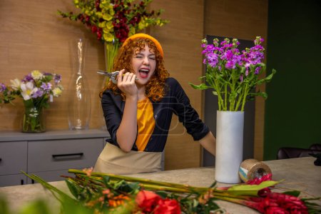 Photo for Work with flowers. Florist preparing flowers for bouquets and looking involved - Royalty Free Image