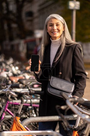 Photo for Street bike. Smiling mature woman renting a street bike - Royalty Free Image