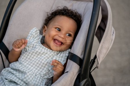 Photo for S,iling baby. Close up of a smiling cute baby in a craddle - Royalty Free Image
