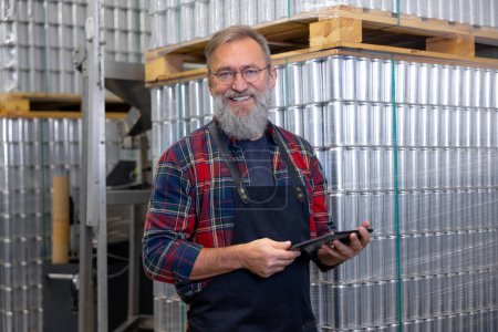 Photo for Brewery. Smiling mature brewery worker at his working place - Royalty Free Image