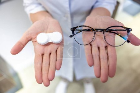 Photo for Eye care. Close up of females hands with eyeglasses and lenses - Royalty Free Image