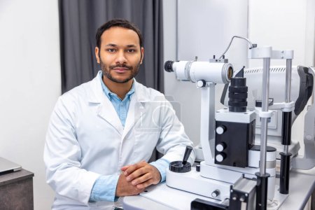 Photo for Optometry. Male doctor working on optometric equipment at clinic - Royalty Free Image