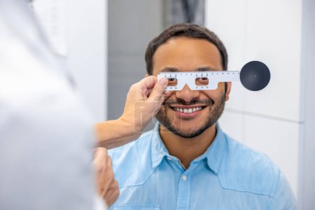Photo for At the doctors. Dark-skinned smiling man having a visit to optometrist - Royalty Free Image
