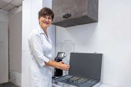 Photo for Medical tools. Doctor working with optometric equipment in clinic - Royalty Free Image
