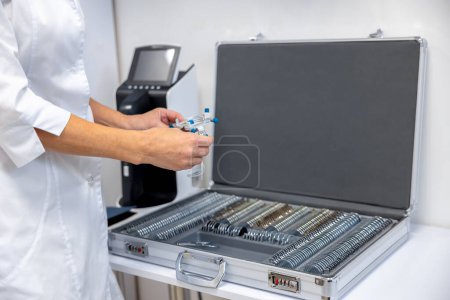 Photo for Medical tools. Doctor working with optometric equipment in clinic - Royalty Free Image