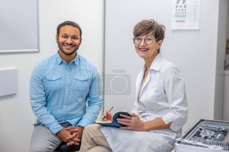 Photo for Measurements. Female optometrist working with a male patient - Royalty Free Image