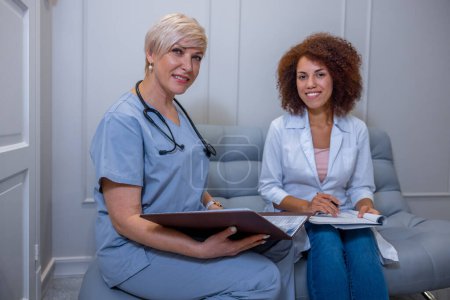 Photo for Looking postitive. Two female doctors at work looking positive - Royalty Free Image