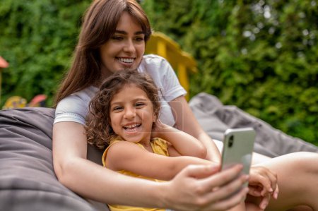 Téléchargez les photos : Happy family. Mom and her cute kid spending time together and making selfie - en image libre de droit