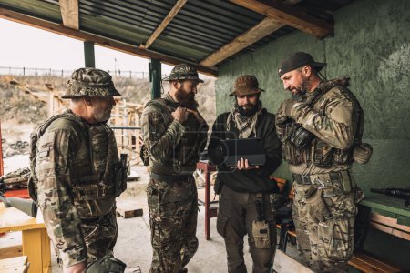 Téléchargez les photos : Soldier before combat. Group of soldiers discussing something before combat - en image libre de droit