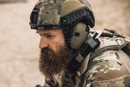 Téléchargez les photos : Warrior. Bearded soldier in military uniform looking determined and serious - en image libre de droit