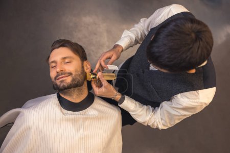Foto de Beard trimming. Barber trimming the clients beard - Imagen libre de derechos