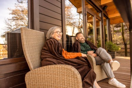 Photo for Peace. Two people sitting in the armchairs on the cottage terrace - Royalty Free Image